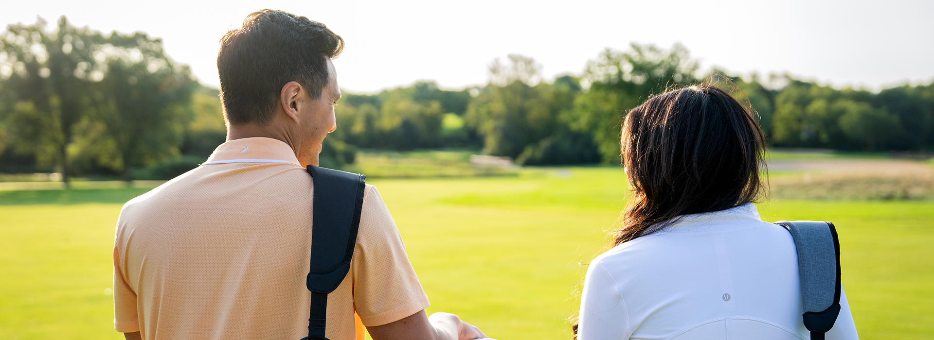 couple with golf bags