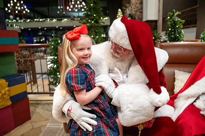 Young girl sitting with Santa
