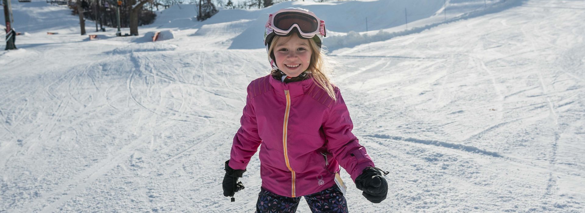 Girl smiling with full ski gear on 