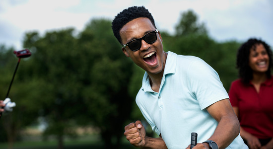 Golfer cheering for a great shot