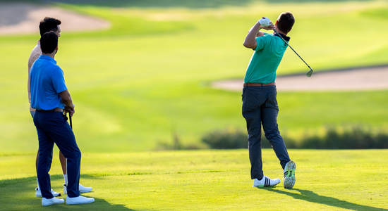 Golfer teeing off