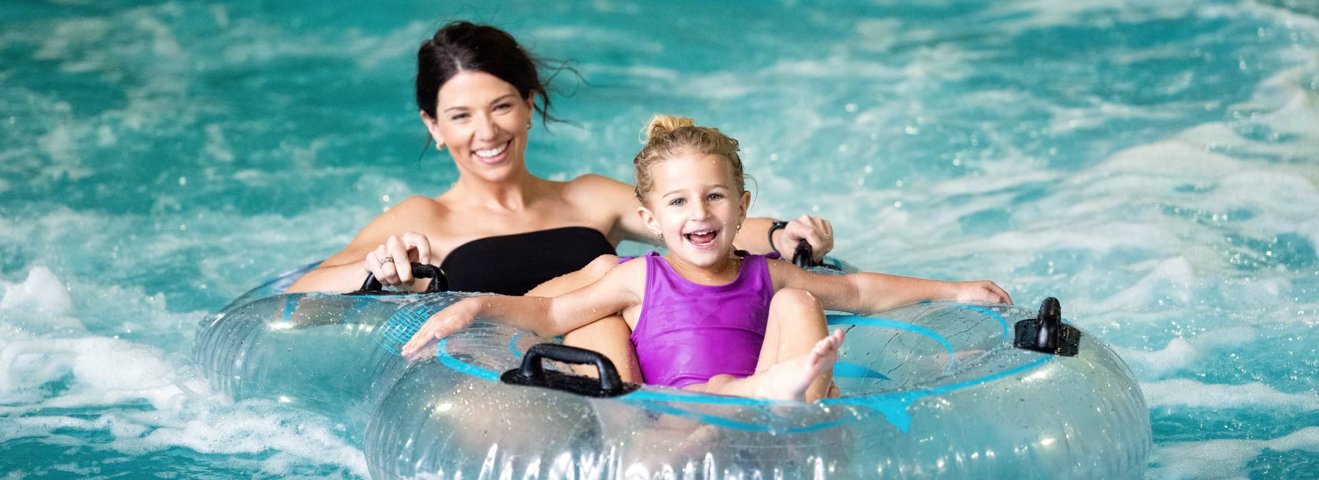 Mom and daughter in a water tube in the waterpark