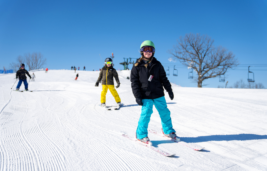 Young girl skiing down The Mountain Top