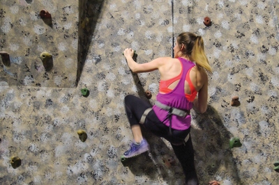 Woman climbing the indoor rock wall